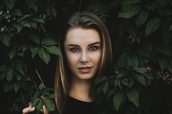 a girl behind tree